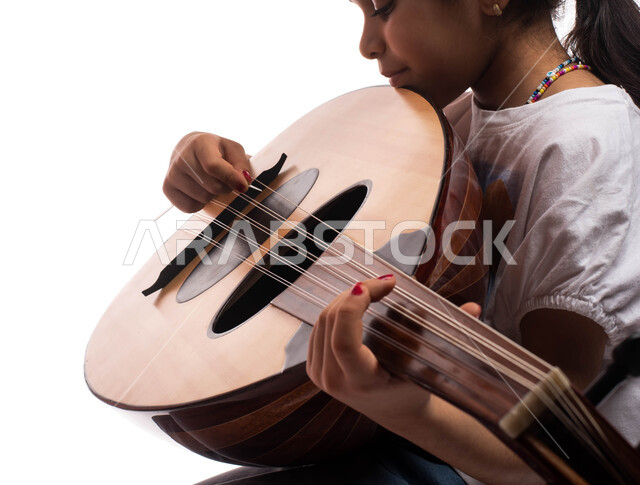 A close-up portrait of a talented Arab Gulf Saudi girl practicing the ...