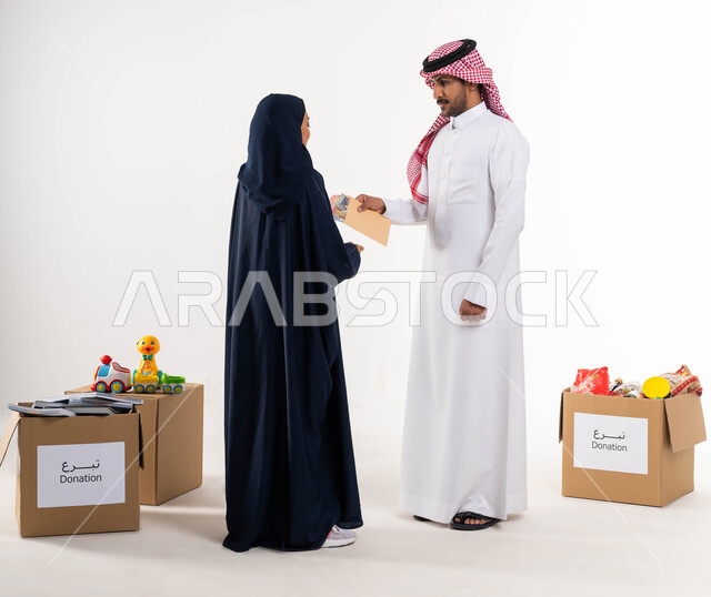Islamic charities in Saudi Arabia, a portrait of a Saudi Arabian Gulf man in traditional dress, offering zakat al-Fitr to deserving families, taking out zakat money for the needy, white background, giving and charity in the month of Ramadan, a full-length