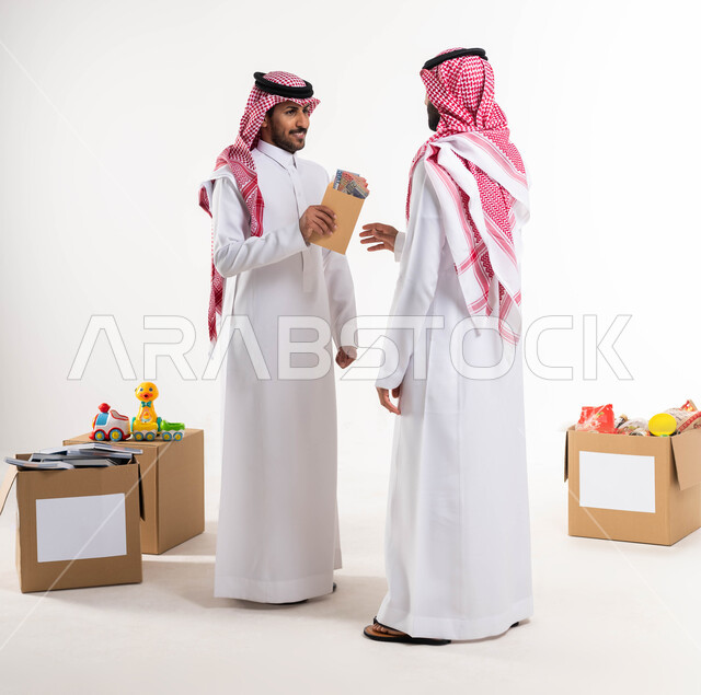 Charity and giving in the month of Ramadan, charities in Saudi Arabia, a portrait of a Saudi Arabian Gulf man offering zakat al-Fitr to the needy, worship and closeness to God, a white background, a full-length picture of the body.