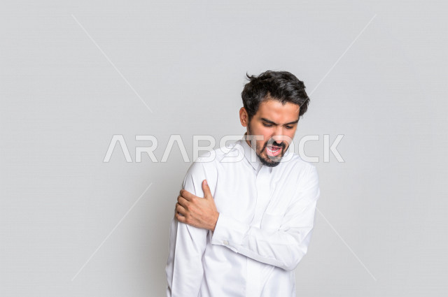 Portrait of a Saudi Arabian Gulf man wearing the Saudi dress, facial and hands gestures indicating headache, headache, feeling sick, tired and exhausted, needing treatment, asking for help, white background.