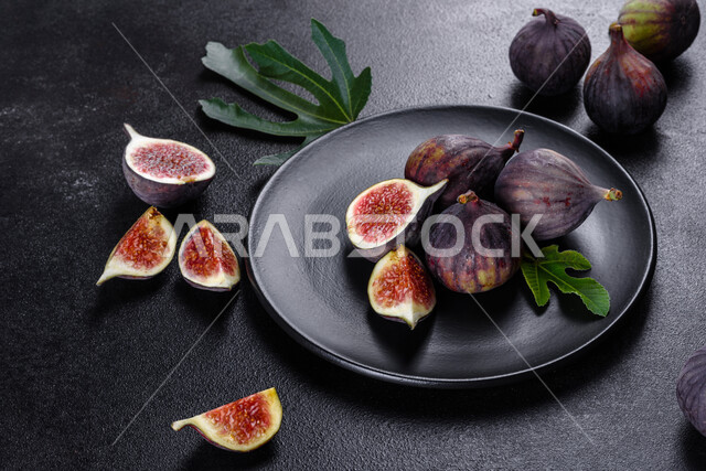 Picture from above of fresh ripe figs, summer fig fruit, healthy and useful, fig harvest, dark background.