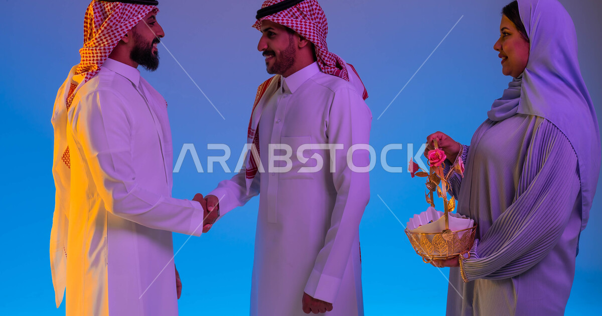 A Saudi Gulf Arab family, a woman providing Eid hospitality, two Saudi men shaking hands, the A Saudi Gulf Arab family, a woman providing Eid hospitality, two Saudi men shaking hands, the