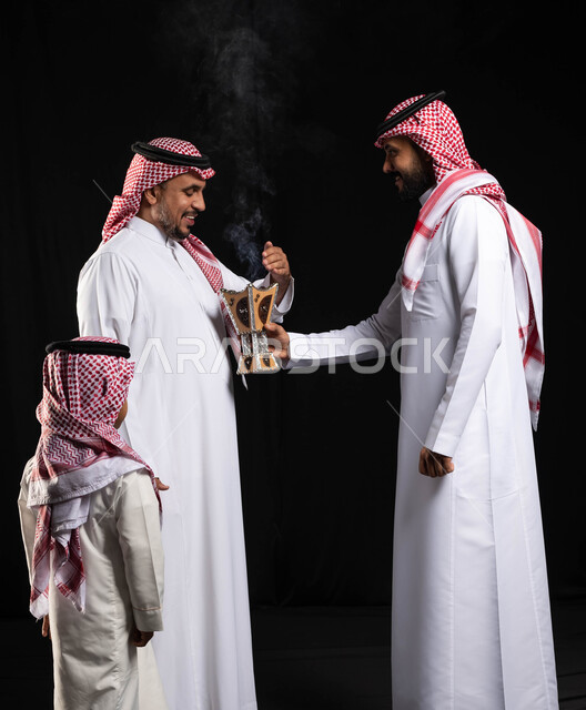 Celebration of the advent of the feast, the use of agarwood, the atmosphere of the feast in Saudi Arabia, the feast visits, the incense holder (the incense burner), a portrait of two Saudi Arabian Gulf men wearing the traditional Saudi dress, a small chil