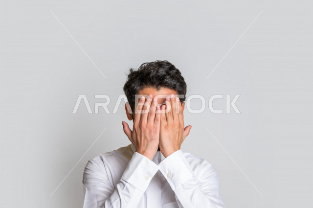 Portrait of a Saudi Arabian Gulf man, wearing traditional Saudi dress, raising his hands up and supplicating to God with different facial and hands gestures denoting supplication and supplication, concept of supplication and need, worship and getting clos
