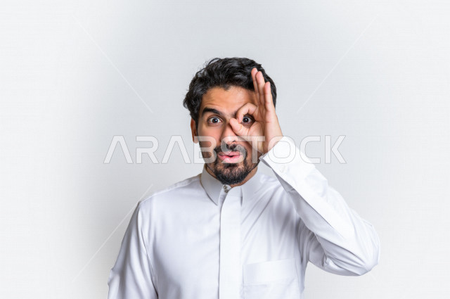 Portrait of a Saudi Arabian Gulf man in traditional dress, making various facial gestures, hand signals indicating a clear vision, future goals, white background.