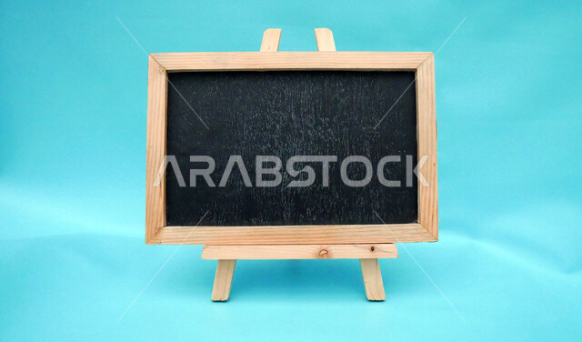 Close-up of a blank blackboard, wood chalkboard frame, small blackboard, blue abstract background