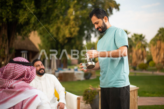 A group of young Saudi Gulf Arabs in a cafe in Saudi Arabia, enjoying the exchange of conversation, spending pleasant times with friends, discussions and dialogues, serving hot drinks, a youth session