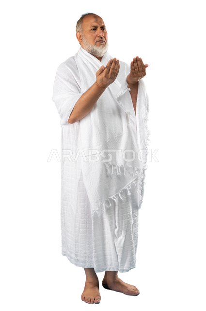 Wearing ihram clothes, a portrait of an elderly, Arab, Saudi, Gulf, Muslim man raising his hands up, supplication, worship, and drawing closer to God,