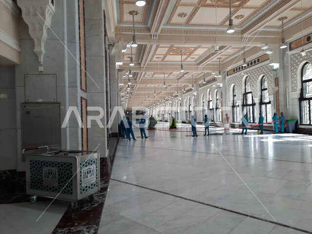 Islamic holy places, a group of workers cleaning between Safa and Marwa in the Grand Mosque in Makkah Al-Mukarramah in the Kingdom of Saudi Arabia, architectural art, worship and closeness to God, Islamic religious landmarks, Islamism and worship