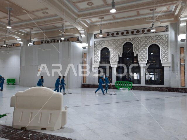 A group of workers cleaning between Safa and Marwa in the Grand Mosque in Makkah Al-Mukarramah in the Kingdom of Saudi Arabia, architectural engineering art, worship and closeness to God, Islamic holy places, Islamic religious landmarks, Islamism and wors