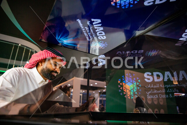 A Saudi Arabian Gulf man at the LEAP International Technical Conference 2023 in Riyadh, modern innovations and technical progress, gestures indicating happiness, a global platform for future technologies and artificial intelligence, towards new horizons f