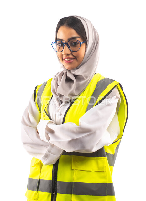 Professions and jobs, getting ready for work, gestures indicating happiness and joy, a portrait of a smiling Saudi Arabian Gulf construction engineer with hands clasped, wearing a helmet and a special safety suit at work, blueprints and engineering design