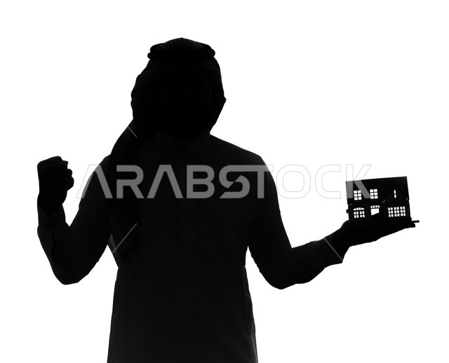 Gestures expressing happiness with the purchase of a new property, a silhouette portrait of a Saudi Arabian Gulf man holding a model of a small house, owning a new home and family stability, housing and ownership, white background, cellulite