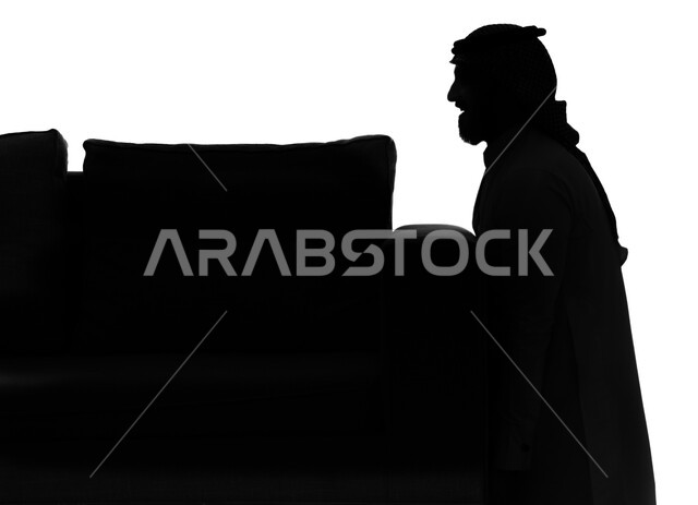 المساعدة والمشاركة في ترتيب وتنظيم المنزل, بورتريه صورة ظلية لرجل عربي سعودي خليجي يقوم بحمل الأريكة ونقل الأثاث، الانتفال الى منزل جديد، امتلاك سكن جديد والاستقرار العائلي, خلفية بيضاء, سيلوليت