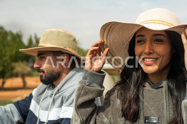 إيماءات وجه تدل على السعادة و السرور, قضاء أوقات ممتعة و مسلية, صورة مقربة لزوجان عربيان خليجيان سعوديان يقومان بجولة سياحية في المملكة العربية السعودية, فعاليات و أنشطة ترفيهية في موسم سفاري في الرياض.