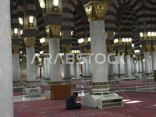 رجل عربي خليجي سعودي يجلس داخل المسجد النبوي الشريف في المدينة المنورة في المملكة العربية السعودية، التصاميم و الزخارف الإسلامية، الفن الهندسي المعماري ، العبادة والتقرب الى الله، اسلاميات وعبادة، أماكن إسلامية مقدسة