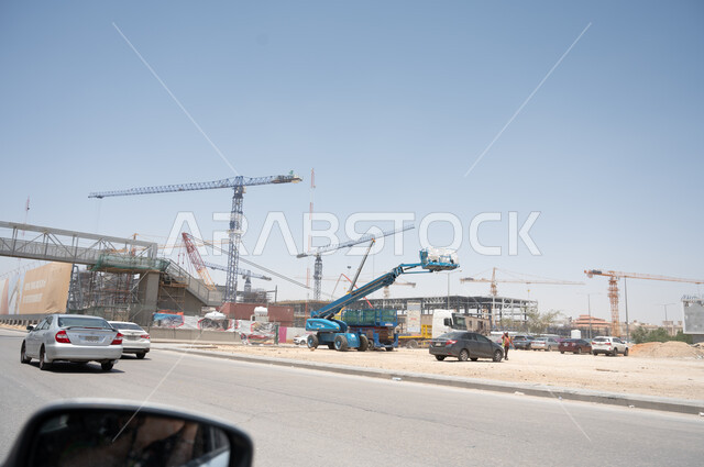 Car traffic in the city of Riyadh in Saudi Arabia, construction equipment and tools, construction trucks and cranes, roads, streets and landmarks of Riyadh, means of transportation