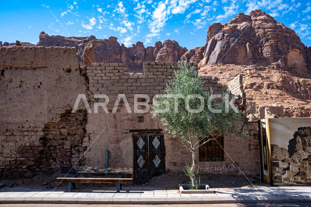 Ancient historical monuments, green trees and plants, ancient houses and buildings in Al-Ula Governorate in the Kingdom of Saudi Arabia, mountain peaks and heights, rock formations in desert areas, tourist places in Saudi Arabia