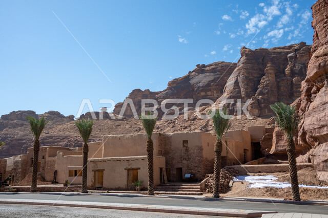 Green green palm trees, rock formations in the desert areas in Al-Ula Governorate in the Kingdom of Saudi Arabia, mountain peaks and heights, ancient houses and buildings, ancient historical monuments, tourist places in Saudi Arabia