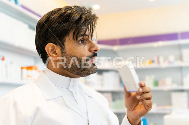 A Saudi Arabian Gulf pharmacist working in the pharmacy, giving instructions on how to use the medicine, preparing the appropriate medicines for the prescription, providing health care, the profession of pharmacy