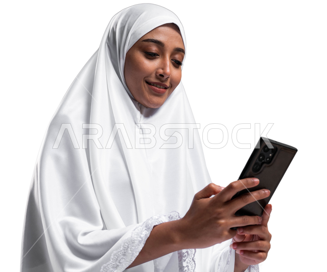 Using mobile applications, a portrait of a Saudi Arabian Gulf Muslim woman wearing ihram clothes and holding a mobile phone in her hand, gestures and facial