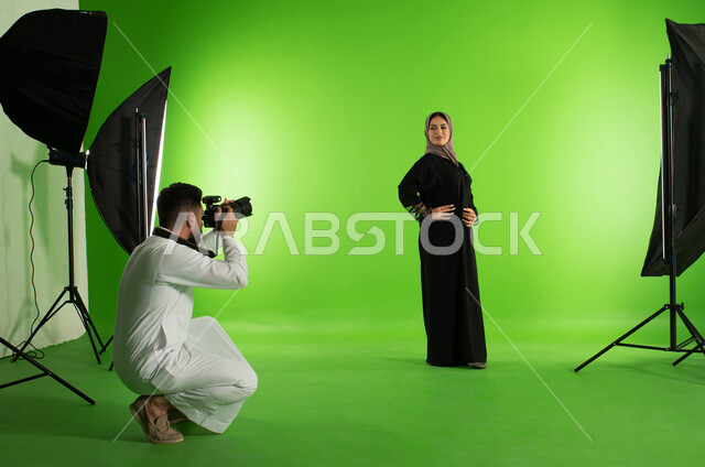 Green screen background, chroma for a photo session in the studio, a professional Saudi Arab Gulf photographer taking photographs of a woman wearing a Gulf women's abaya, advanced cameras and equipment, marketing advertising photography, a fashion model a