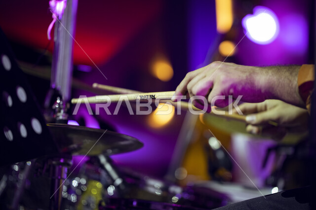 Drumming using percussion instruments, a close-up of the hands of a Saudi Arabian Gulf man playing a drum during the Tanween season for educational, recreational and cultural activities, presenting musical and theatrical arts at the King Abdulaziz Cultura