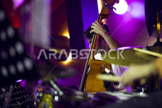 Playing the violin during the Tanween season for entertainment, cultural and educational activities. A close-up of the hands of a young Saudi man playing the stringed violin. Playing and entertainment activities at the King Abdulaziz Center for World Cult