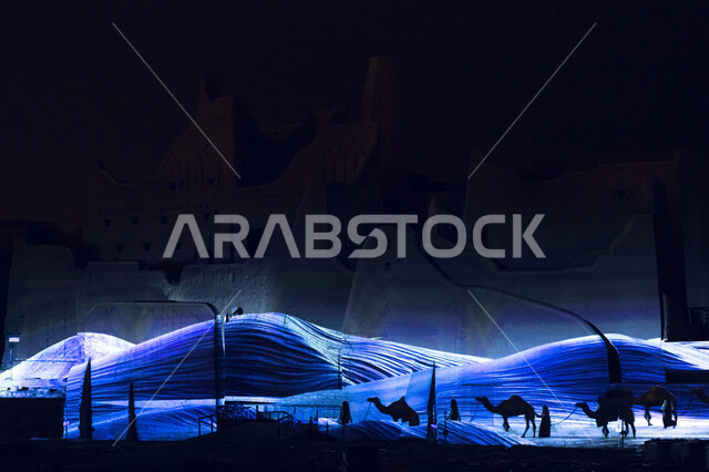 قافلة جمال في الصحراء في وضع الليل ، مجموعة من الإبل بين الكثبان الرمليه ، خلفية البيئه الصحراويه.