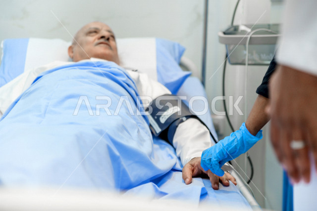 An old man, Arab, Gulf, Saudi, patient lying on a hospital bed, receiving treatment and care in the hospital, performing surgery, a hospital for the elderly, the concept of medicine and health care