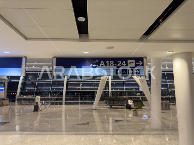 An indicative electronic screen to locate and know flight numbers, air travel flights, interior decorations and the distinguished engineering art of Jeddah International Airport in the Kingdom of Saudi Arabia, passenger reception halls, providing high-end