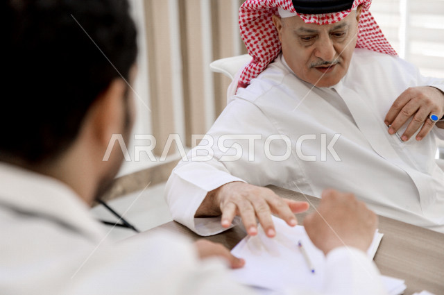 رجل عربي خليجي سعودي في موعد مع طبيب استشاري اخصائي سعودي ، طبيب اخصائي في المستشفى يقدم الاستشارات الطبية والخدمات الصحية  ، مفهوم الطب والرعاية الصحية