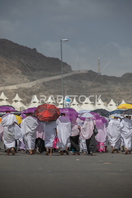 Performing religious duties, pilgrims to the Sacred House of God wearing the Ihram garments in Makkah Al-Mukarramah in the Kingdom of Saudi Arabia in Mina, performing the rituals of Hajj and Umrah, worshiping and drawing closer to God in Islamic religious