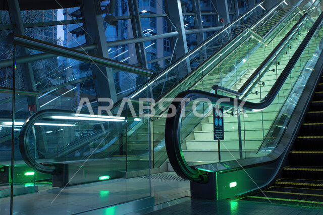 The distinctive engineering design of train stations in the United Arab Emirates, a close-up of escalators inside the Dubai Metro, a rail network for rapid transportation in Dubai, movement within the metro stations