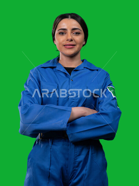 Support and development of the space sector in Saudi Arabia, portrait of a smiling Gulf Arab female astronaut wearing a space suit looking at the camera, gestures of two hands crossed, Saudi Arabia's journey towards the outside world, the emblem of the Sa