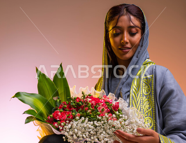 Shops and shops buying and selling natural flowers, different face and hand gestures indicating happiness and joy, buying bouquets of flowers on holidays and happy occasions, a close-up portrait of a young Saudi Arabian Gulf woman wearing a modern embroid
