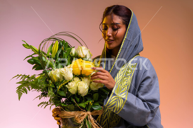 Arranging bouquets of natural flowers on holidays and happy occasions, gestures indicating joy and happiness, a close-up portrait of a young Saudi Arabian Gulf woman wearing the modern abaya holding a luxurious vase of roses in her hand, shops and stores 