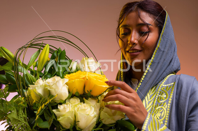 Owning bouquets of flowers on holidays and happy occasions, gestures indicating joy and happiness, a close-up portrait of a young Saudi Arabian Gulf woman wearing the modern abaya holding a luxurious vase of roses in her hand, shops and stores buying and 