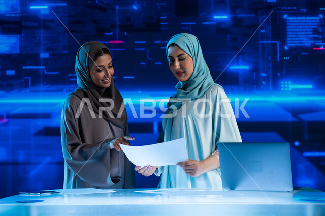 Business dialogues and discussions, development of companies and economic projects, financial investment and electronic commerce, two Saudi Arabian Gulf employees in a business meeting at the company's headquarters, monitoring the stock market and the sto