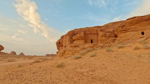 Old Nabatean architecture carved on orange sandstone wall at Jabal Al Ahmar..