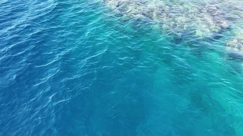 Aerial view drone flying over blue sea. Beautiful sea waves and coral reef water