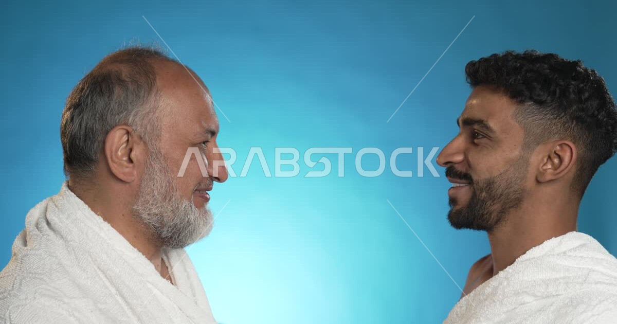 Wearing Ihram clothes, a close-up of a Saudi Arabian Gulf youth kissing ...