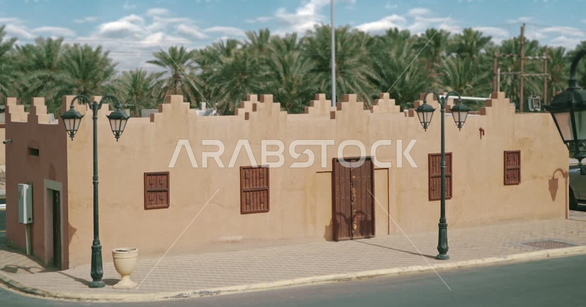 Ancient houses and buildings in the village of AlQarah in AlAhsa Governorate, green palm trees