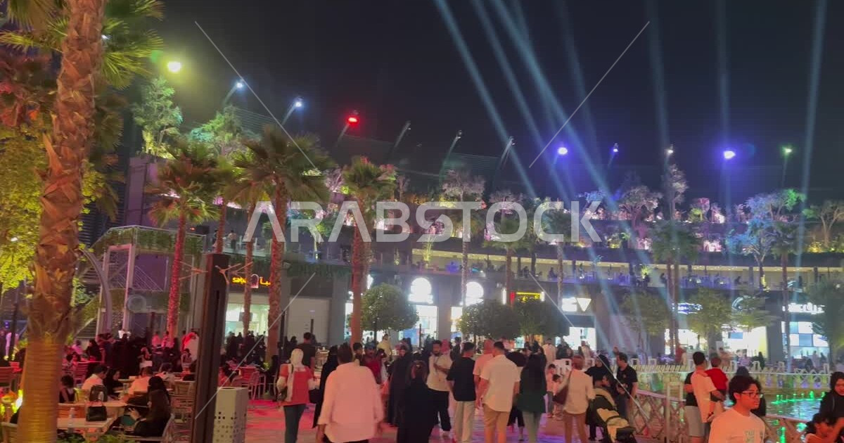 Visitors gathered in Square 2 in Riyadh Boulevard, green palm trees and