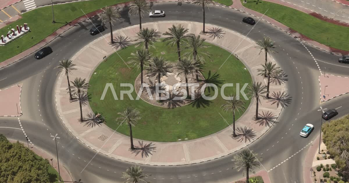 Traffic roundabout on Sheikh Zayed Road in Dubai, aerial view of car
