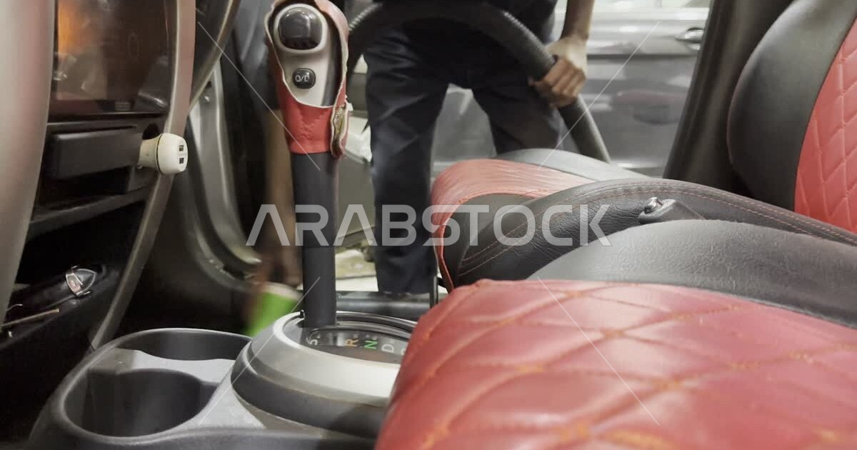 Cleaning interior seats using a vacuum cleaner, car wash station in the