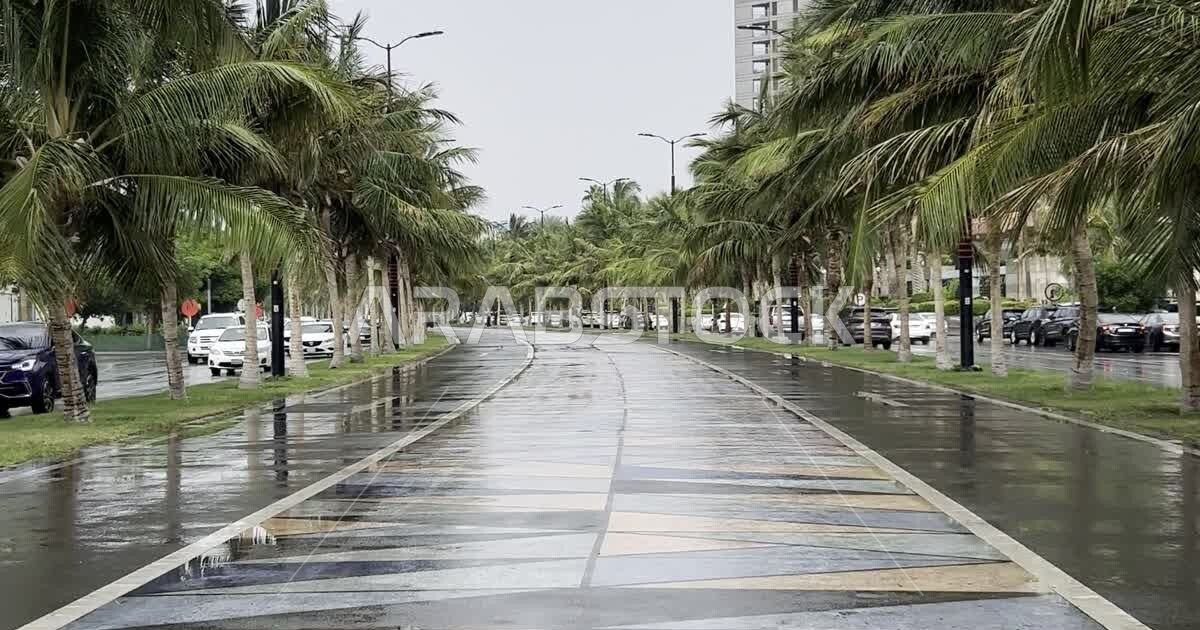 Corniche walkway wet with rain water, rainy winter weather in the