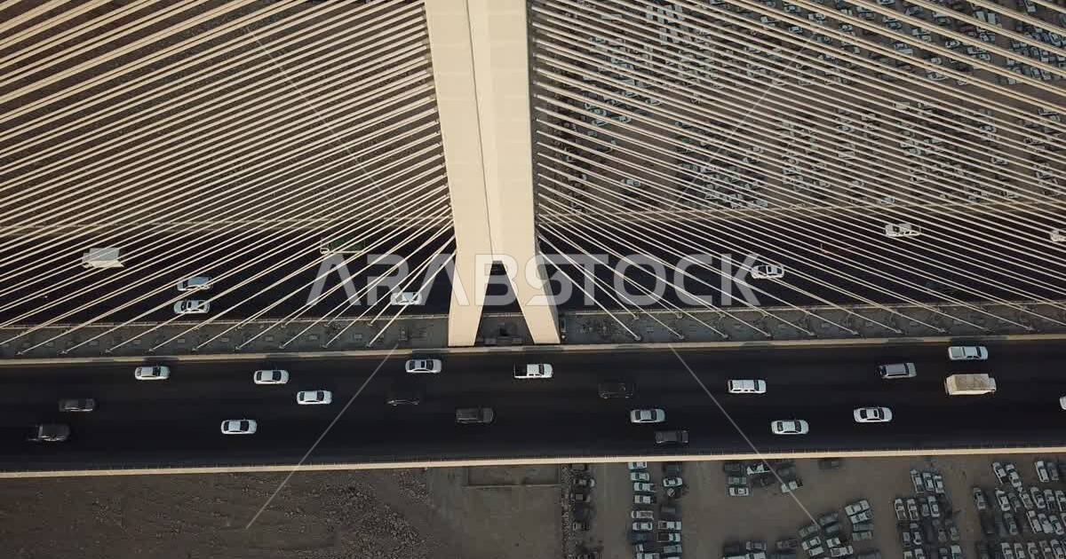 Car traffic on the Wadi Laban cablestayed bridge, mountains and sand