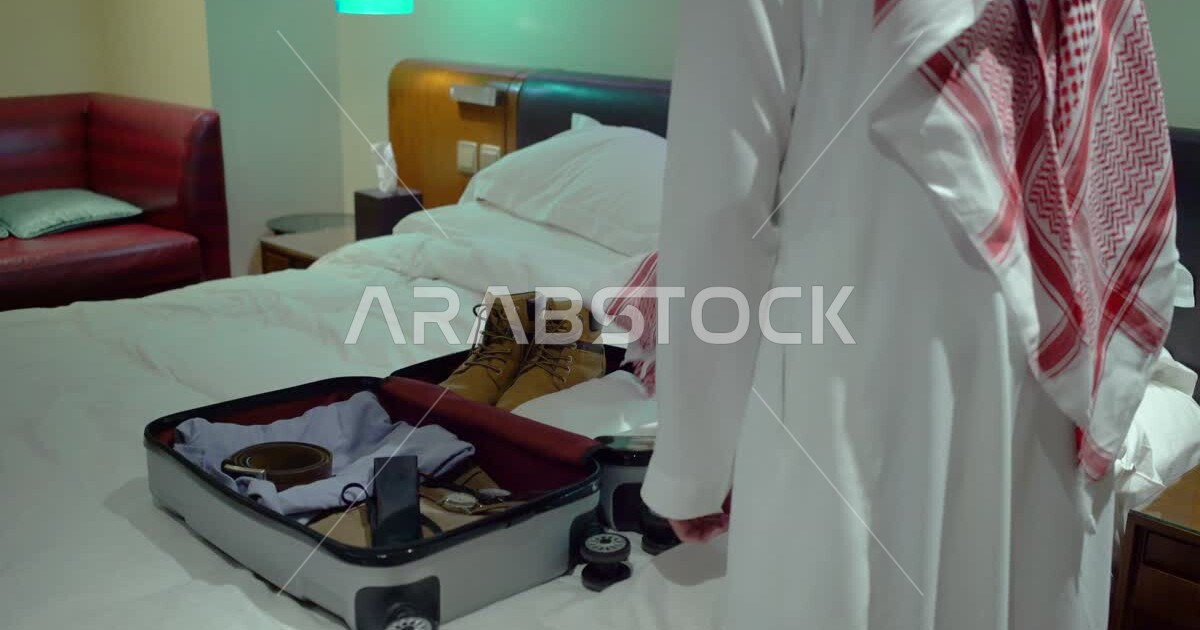 A Gulf man's travel bag puts his personal needs of clothes and shoes in