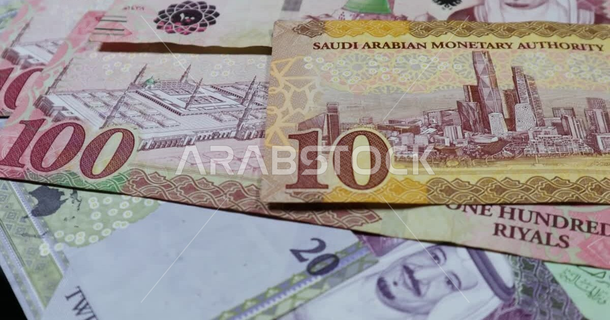 Saudi Riyal banknotes circulating on a display table, financial ...
